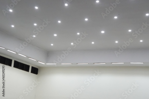 Modern Room Interior with Recessed Lighting and Air Vents.
