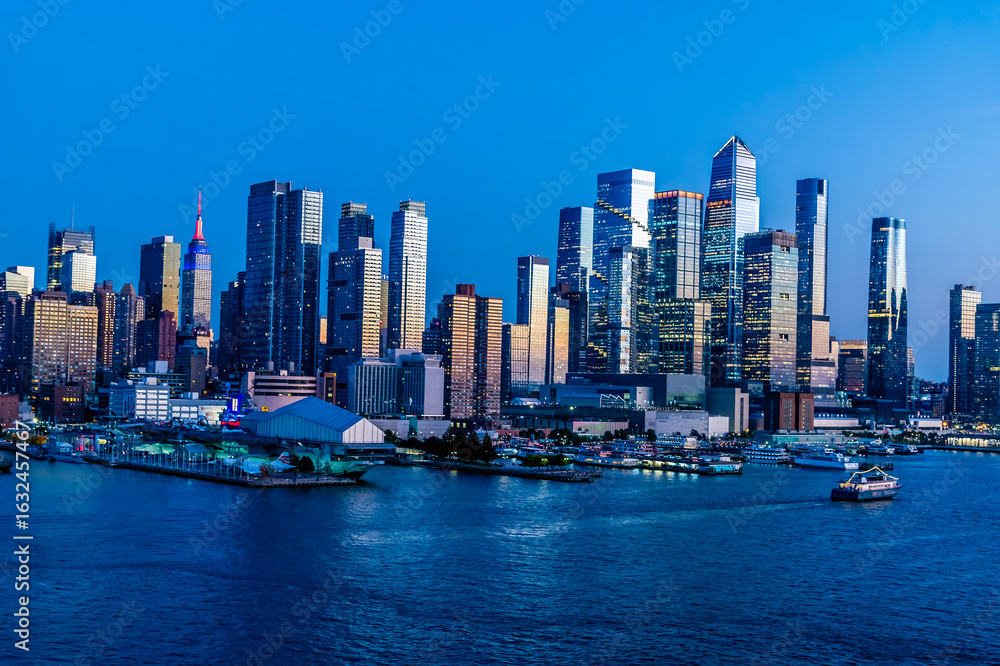 Naklejka premium A view at dusk from the Hudson River towards Hudson Yards in Manhattan, New York, in the fall