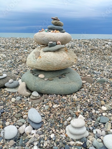 Photography A large zen cairn of stones representing stability and tranquility on a pebble b
