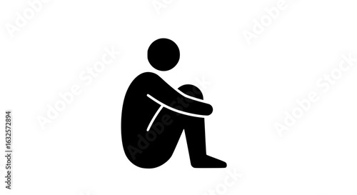 A person is hugging their knees black and white