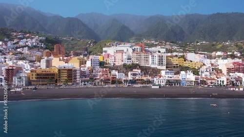 Aerial of Santa Cruz de la Palma capital town of La Palma island with colorful houses and black sand beach in sunny winter day