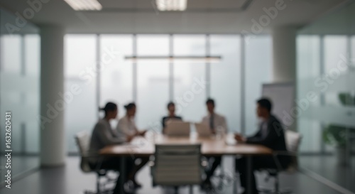 Illustration of blurred image of business people in a meeting at the office around a table