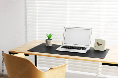 Wallpaper Mural Stylish workplace with laptop and black mousepad on wooden table indoors. Space for text Torontodigital.ca