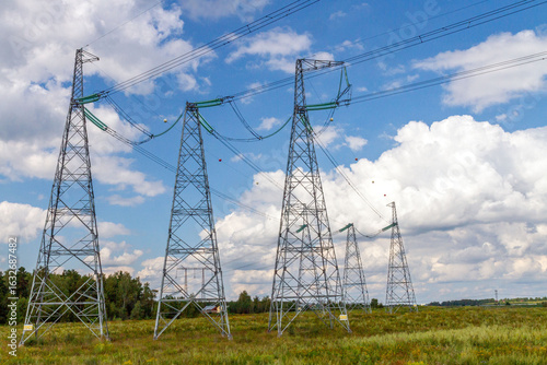 Wallpaper Mural High voltage power transmission towers in rural area under blue sky. Torontodigital.ca