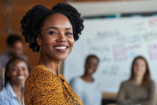 Smiling black businesswoman leading brainstorming meeting in modern office