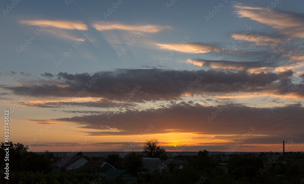 Obraz premium Landscape at sunset. Tragic gloomy sky. Panorama. Crimson twilight.