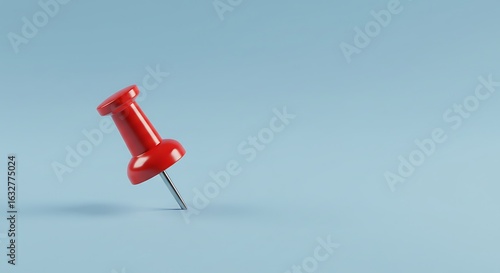 Red Push Pin on Light Blue Background Close Up
