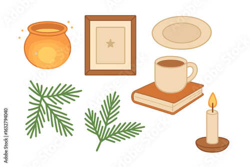 Cozy arrangement of winter-themed decor featuring a pot, candle, book, and greenery near the warmth of a mug of hot drink