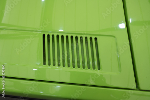 Slika na platnu Close-Up of Green Classic Car Body Vent Detail