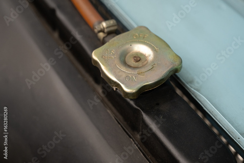 Wallpaper Mural Close-up of vintage car radiator cap. Detailed macro shot of an old brass radiator cap on a classic vehicle, highlighting aged metal texture and mechanical design.

 Torontodigital.ca