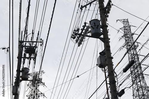 Obraz na płótnie 複雑に絡む電線と電柱、密集するインフラ設備
