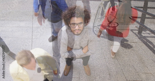 Slika na platnu Standing bearded man wearing glasses and sweater looking upward on station conco
