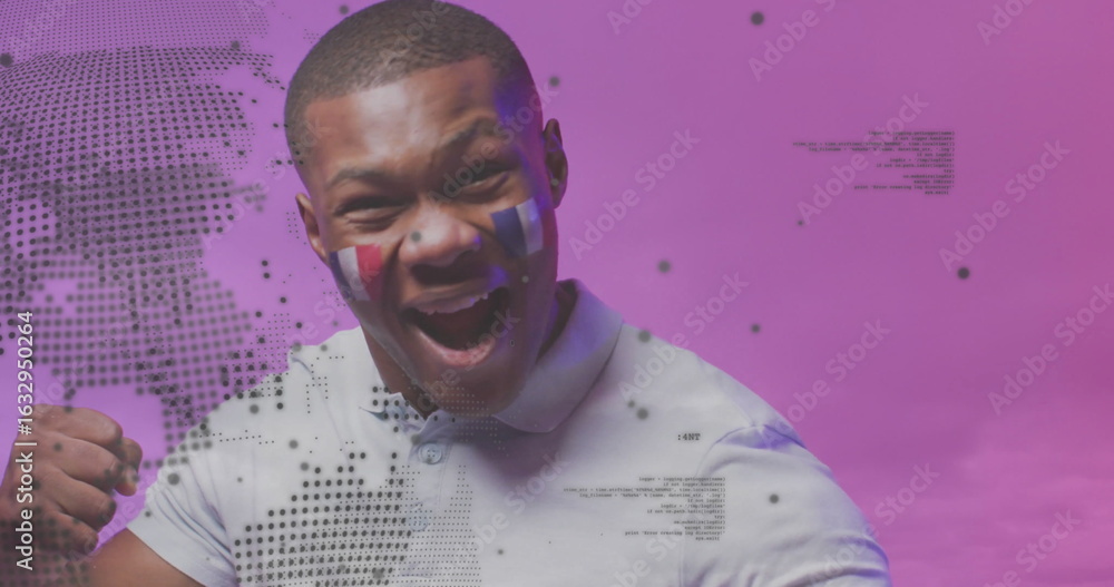 Fototapeta premium Shouting fan raising fist in studio, with French flag face paint and world map code overlays