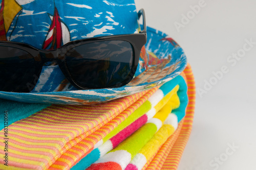 sun hat, glasses and beach towel
