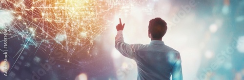 Wallpaper Mural A male figure with light brown hair, dressed in a white shirt, points towards a futuristic visualization of digital connections, symbolizing innovation and technology in a vibrant setting. Torontodigital.ca
