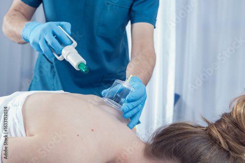 Wallpaper Mural  Modern Physiotherapy Clinic with Medical Team – Therapist Assisting Patient and Doctor Performing Examination,Rehabilitation Clinic Scene – Physiotherapist, Doctor, and Medical Assistant Working with Torontodigital.ca