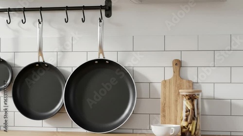 Pans Hanging in Kitchen on White Tile Wall