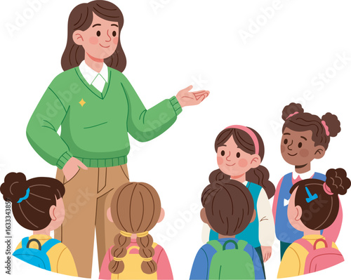 A friendly female teacher in a green sweater gesturing towards a diverse group of attentive elementary school children.