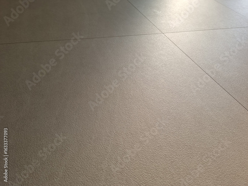 The living room has a beige hardwood floor.