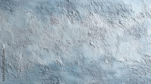 A detailed close-up photograph reveals the textured surface of a light blue wall with varying shades and brush strokes.