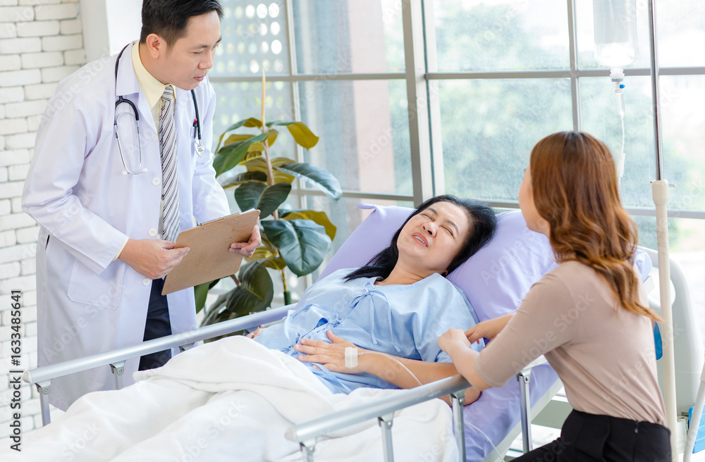Obraz premium Asian man professional doctor visiting ward, consulting talking to physician, senior woman patient lying on hospital bed experiencing pain symptoms with her lovely daughter family showing care support