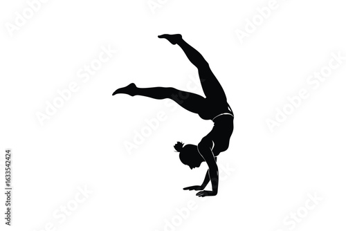 Athletic woman performing a graceful handstand with one leg extended upwards and the other bent showcasing flexibility and strength in a striking silhouette