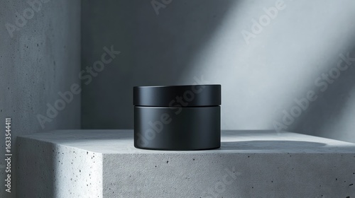 Matte black cosmetic jar on a concrete shelf, bathed in natural light