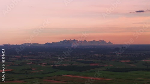 Wallpaper Mural Aerial view of Peaceful pink sunset sky and distant mountains during twilight over green rural landscape Torontodigital.ca