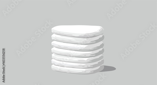 Stack of pale white, rounded disks with a small shadow on gray