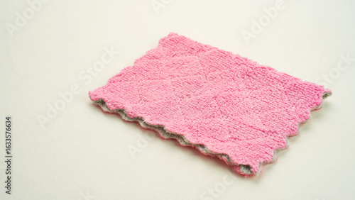 Clean pink microfiber cloth isolated on white, top view
