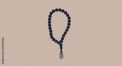 Beaded prayer beads with tassel on taupe background