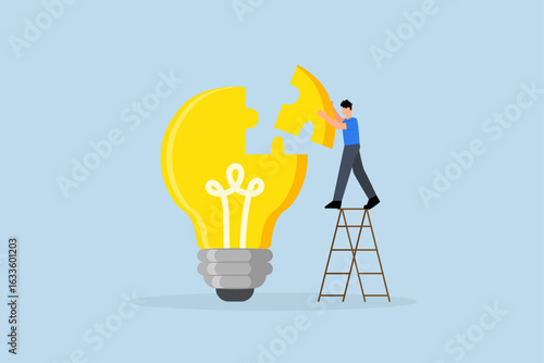 Solve business problem with creativity, Businessman put together final jigsaw piece to finish puzzle of idea for lightbulb