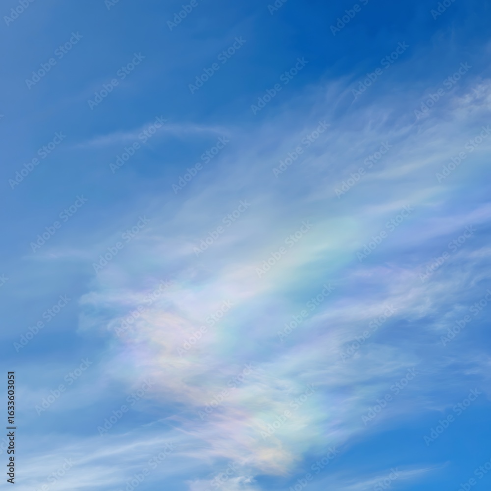 Fototapeta premium Iridescent clouds display shimmering pastel colors against a bright, clear blue daytime sky