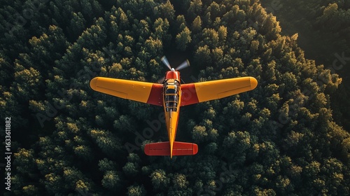 Small orange-red airplane above dense forest