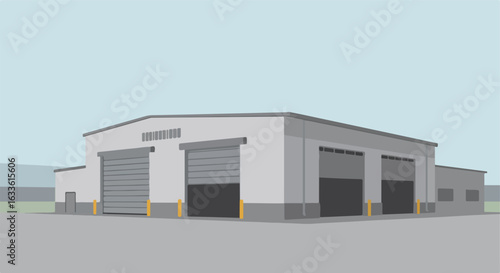 Gray building with roller doors, open and closed, on grey tarmac with blue sky