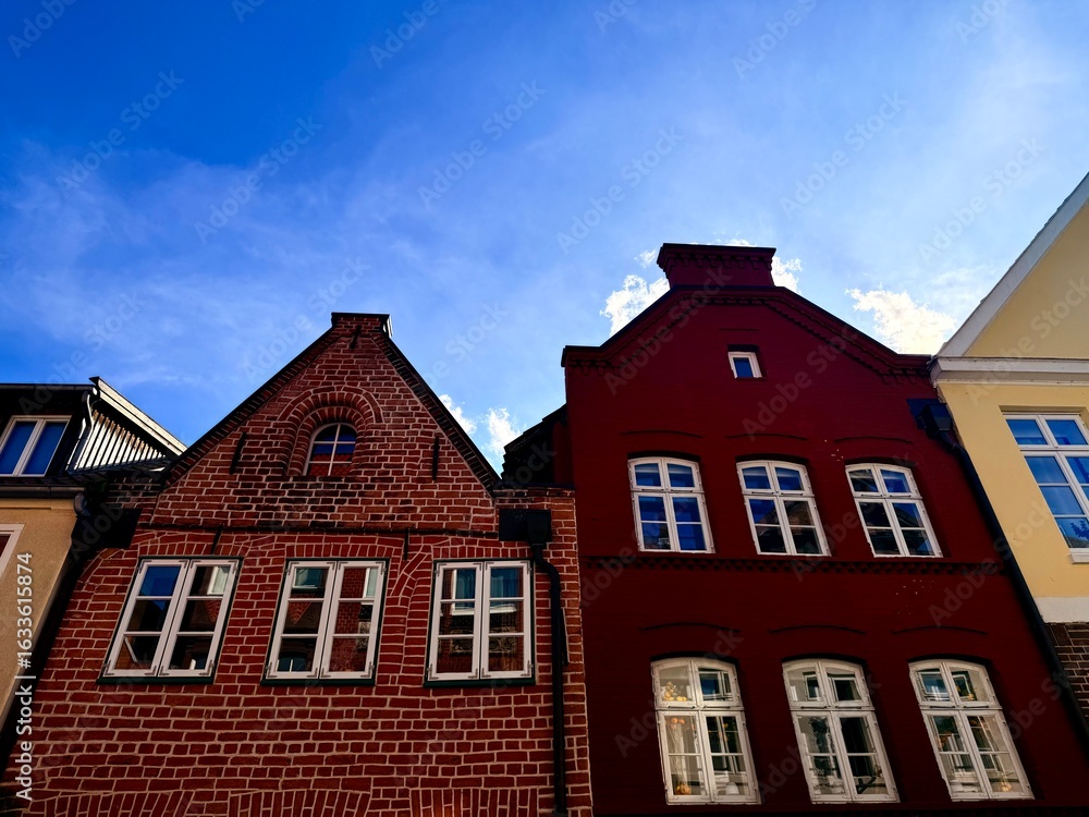 Fototapeta premium beautiful medieval houses , colorful, street of an old europenean town, blue sky
