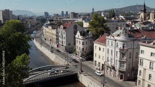 Aerial view of Sarajevo the capital of Bosnia and Herzegovina with the river Miljacka and cars on the road