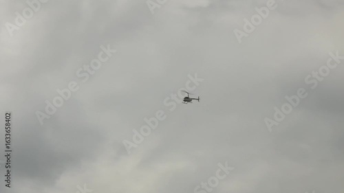 The helicopter flies in cloudy weather