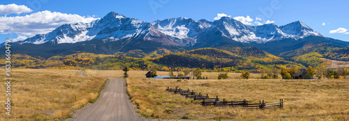 Autumn Mountain Country-Road - A panoramic Autumn view of a country road extending towards towering snow-capped Wilson Peak. Telluride, Colorado, USA.