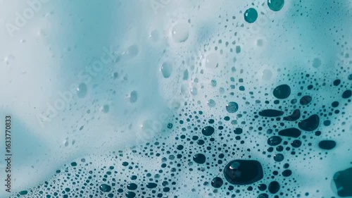 Close-up of vibrant blue soap suds and bubbles pattern