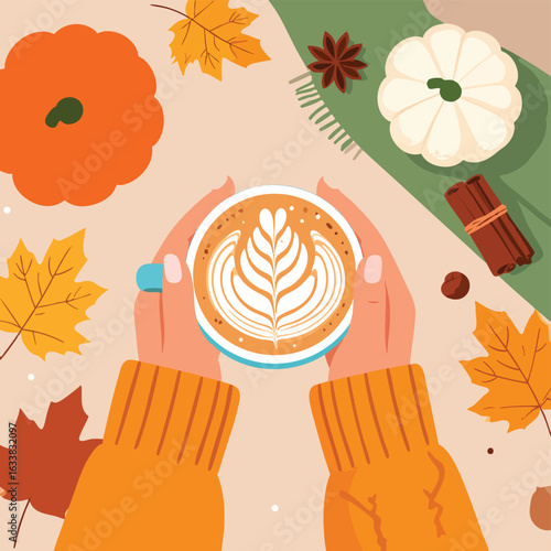 Warm hands holding a latte with autumn leaves and pumpkins.