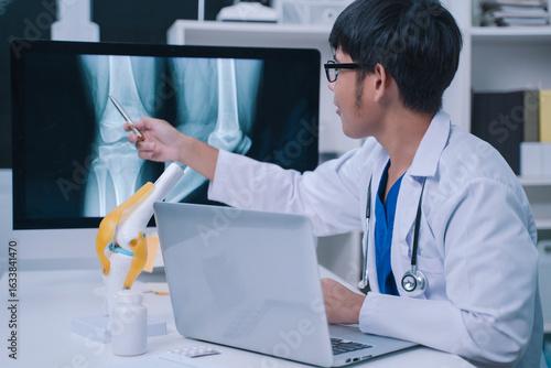 At the hospital, the doctor reviewed the x-ray of the human knee, examining the bone structure to assess the patient's health and determine the best treatment plan.