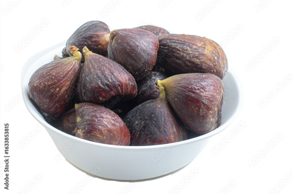 Fototapeta premium a bowl of figs on a white table