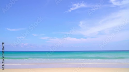 Wallpaper Mural Coastal scene ocean waves rolling onto a sandy beach under a blue sky Torontodigital.ca