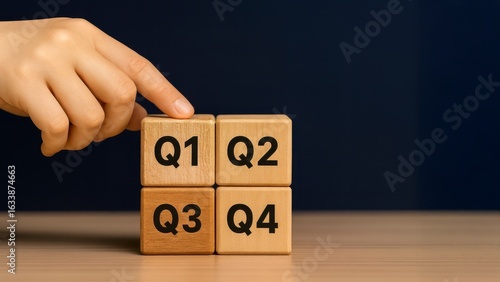 Business Planning Concept with Q1 Q2 Q3 Q4 Wooden Blocks in Hand