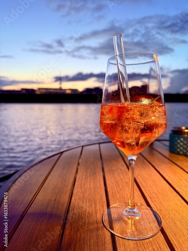 aperol glass at the lake restaurant, sunset time