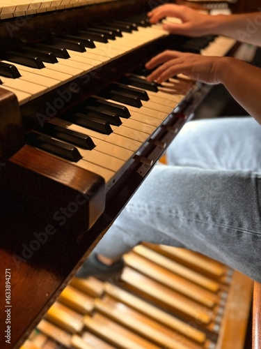 young woman playing organ, two manuals and pedal