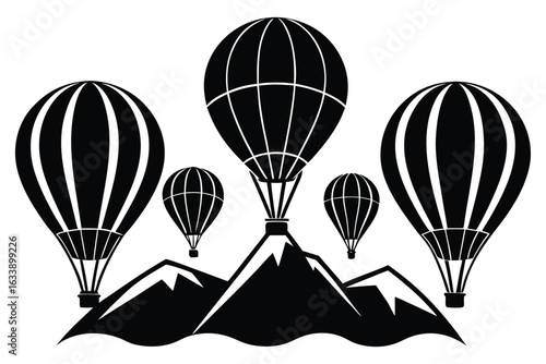 Hot air balloons flying over mountains silhouette