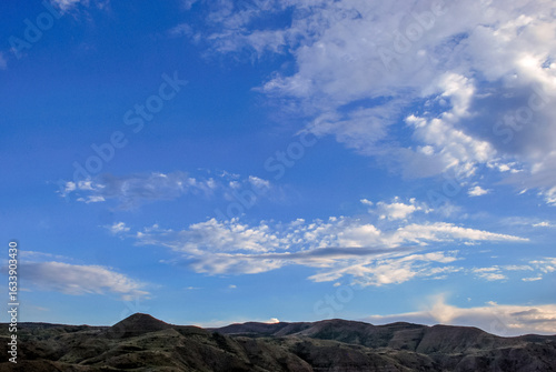 Rolling hills and expansive sky at sunset over serene landscape