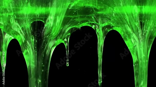 Abstract Green Slime Dripping: An artistic, abstract close-up of neon-green, liquid slime dripping against a backdrop. This image embodies themes of texture and creativity.